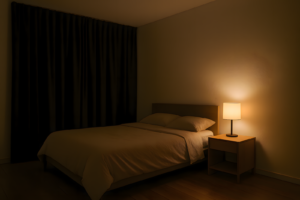 Minimalist bedroom with blackout curtains and amber lighting designed for better sleep